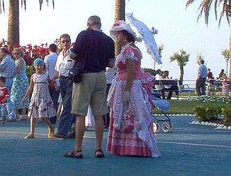 A lady in victorian dress amongst the other people
